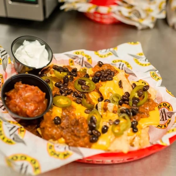 Wings to Go nachos with cheese, chili, black beans, jalapeños, salsa, and sour cream.