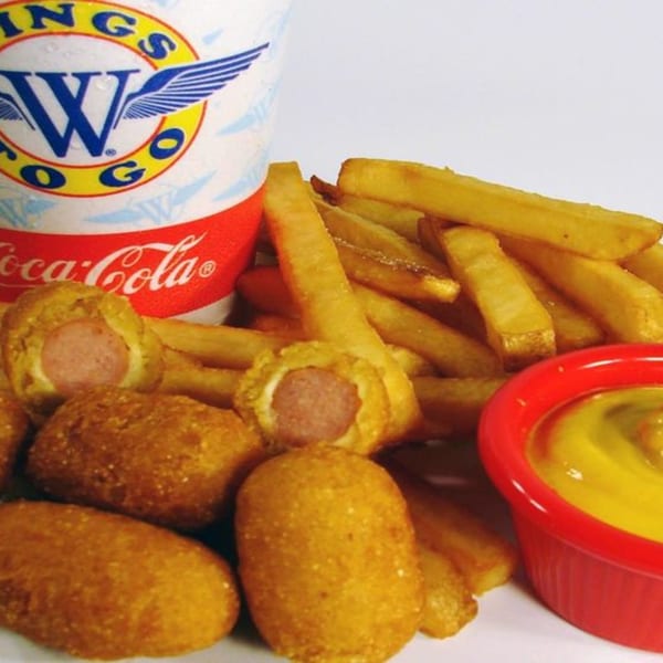Wings to Go corn dogs, french fries, mustard, and a Coca-Cola cup.